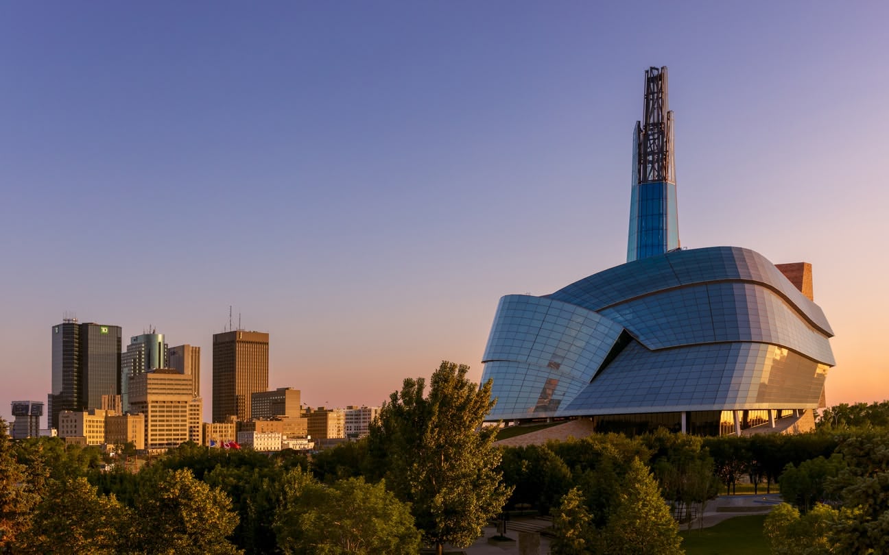 Scenic views of various Canadian cities, showcasing expansive urban landscapes and skylines from elevated vantage points.