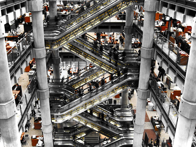 Image of a busy office with escalators
